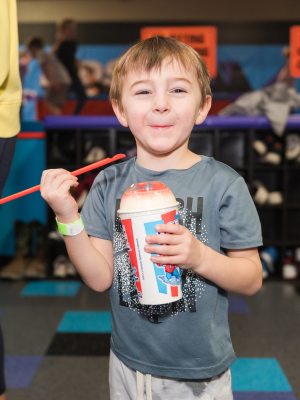 cute kid eating a slushee at Altitude