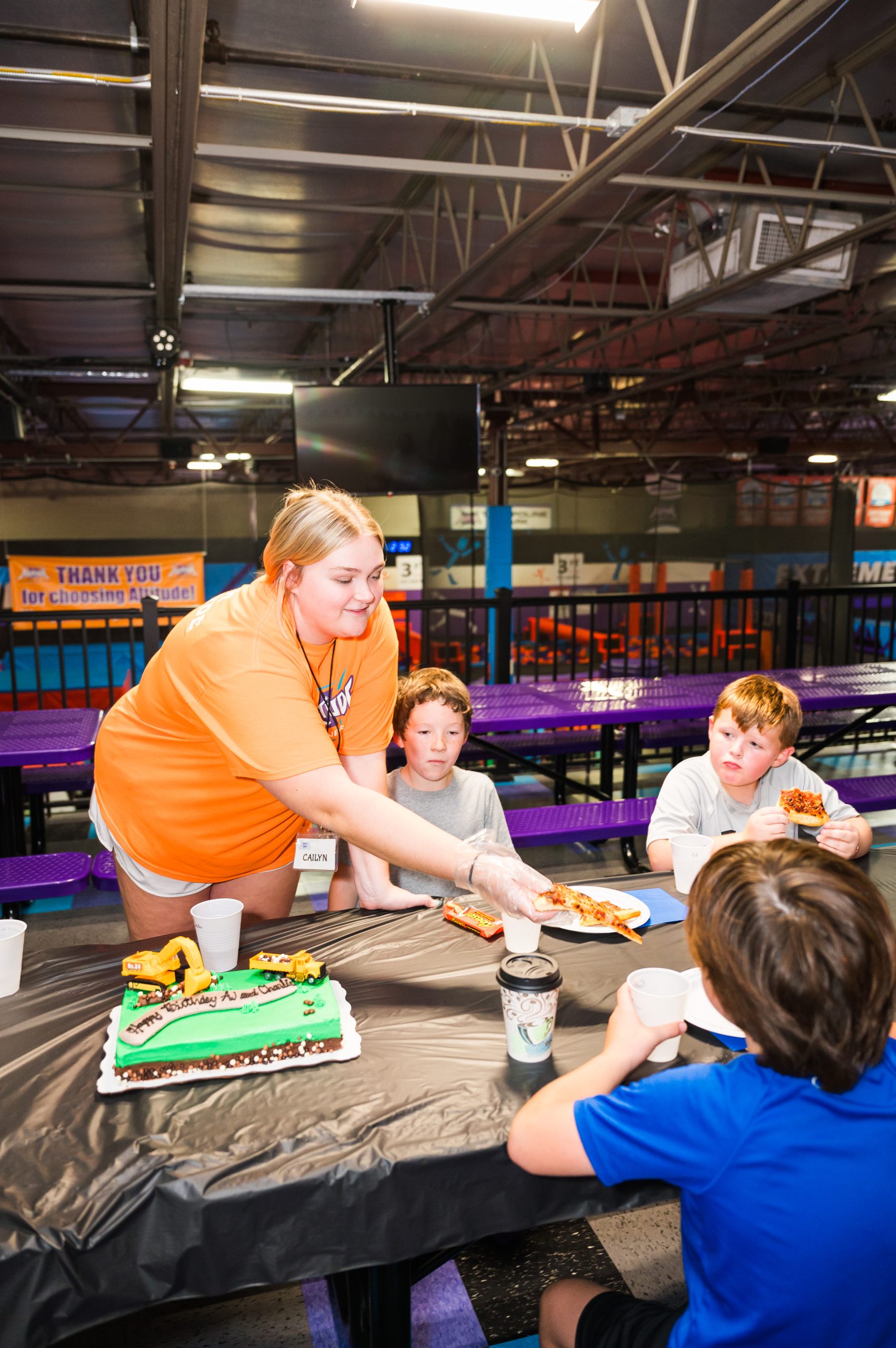 Altitude Bloomington staff serving cake at a birthday party